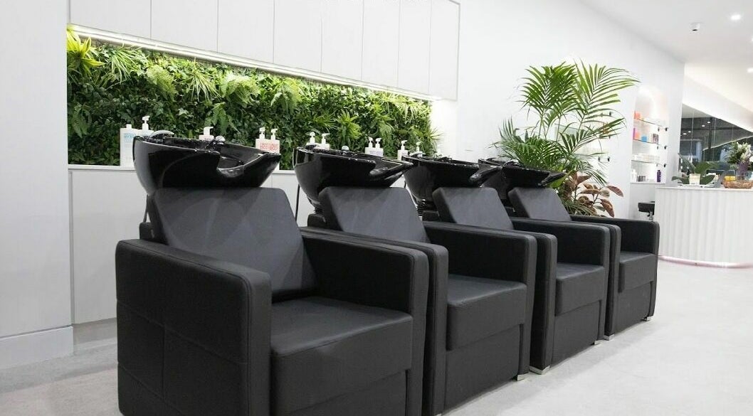 Luxurious wash stations at Maliha Salon And Barber, Melbourne, Victoria, AU, with a lush plant backdrop.