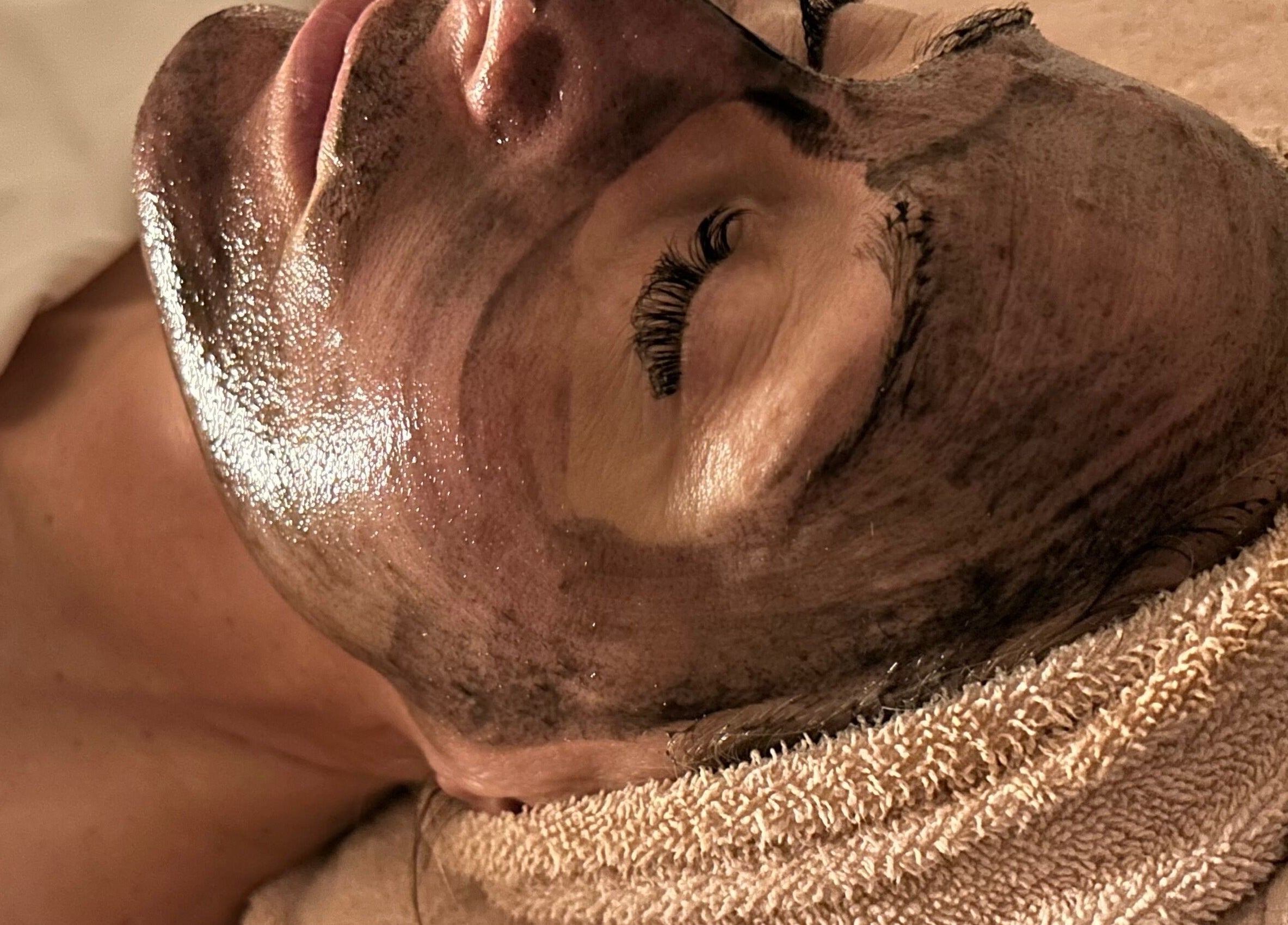 Facial treatment at Raven & Rose Aesthetics LLC in Stevens Point, Wisconsin, US, showcasing a relaxing mud mask.