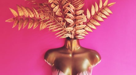 Artistic golden mannequin with leaf headdress at Shepack Beauty, Paignton, England, GB.