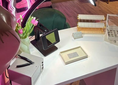 Elegant jewelry display at Shepack Beauty, Paignton, England, GB with pink tulips on a white desk.