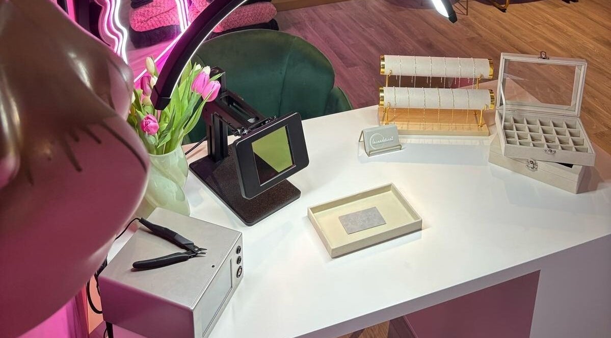 Elegant jewelry display at Shepack Beauty, Paignton, England, GB with pink tulips on a white desk.
