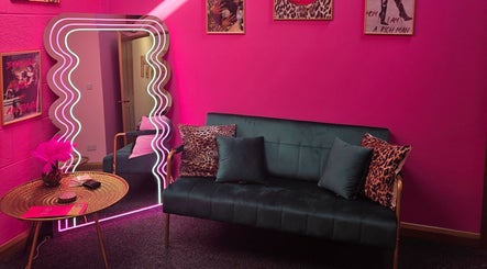 Stylish pink lounge at Shepack Beauty, Paignton, England, GB, featuring modern decor and chic accents.