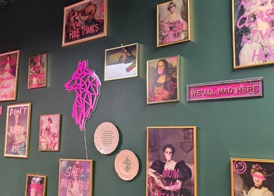 Vibrant eclectic wall art at Shepack Beauty, Paignton, England, GB, featuring neon accents and unique frames.