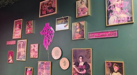 Vibrant eclectic wall art at Shepack Beauty, Paignton, England, GB, featuring neon accents and unique frames.