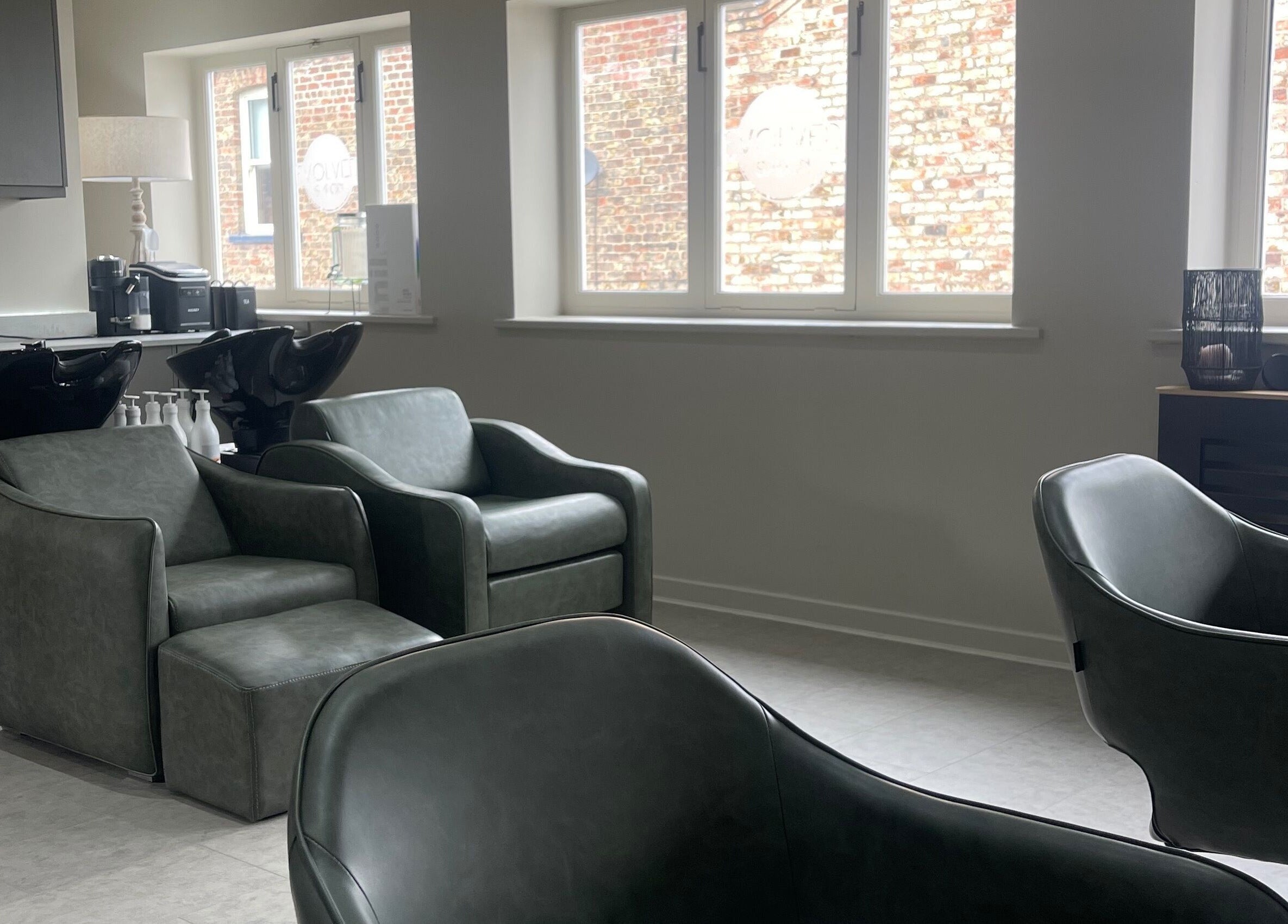 Modern salon chairs and basins at Evolved Salon, Boroughbridge, England, GB, showcasing stylish interior design.