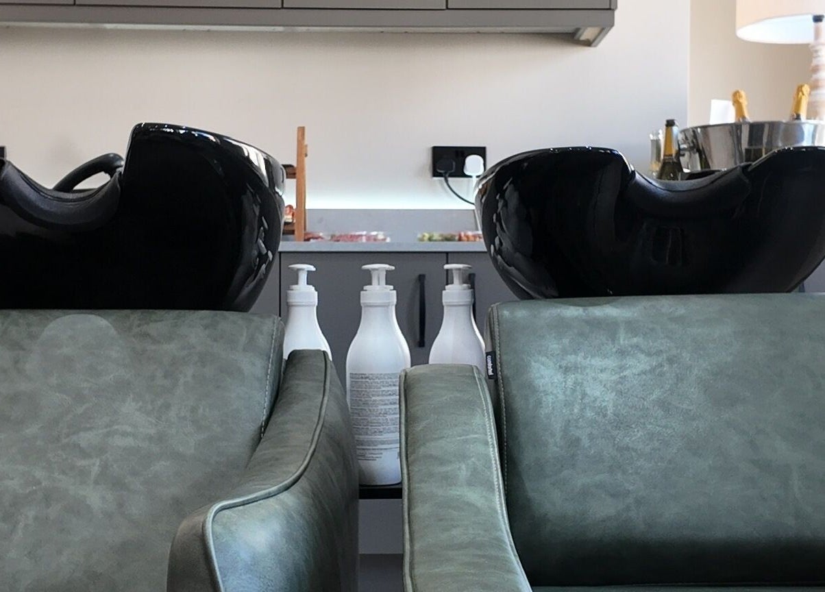 Modern wash basins and seating at Evolved Salon, Boroughbridge, England, GB. Experience luxury hair care.