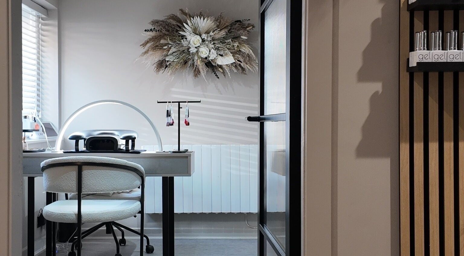 Cozy nail station at Evolved Salon, Boroughbridge, England, GB featuring elegant decor and professional tools.