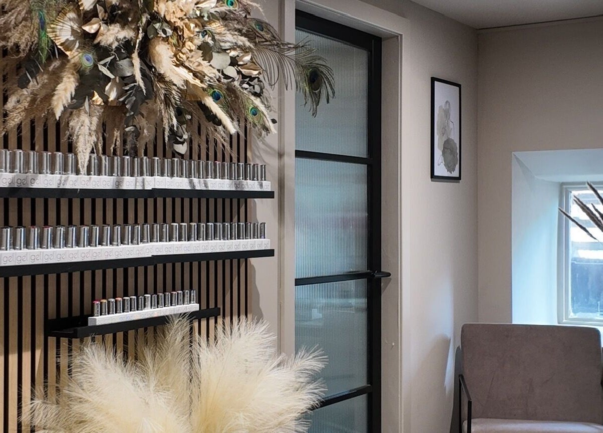 Modern nail polish display at Evolved Salon in Boroughbridge, England, GB featuring elegant decor and seating.