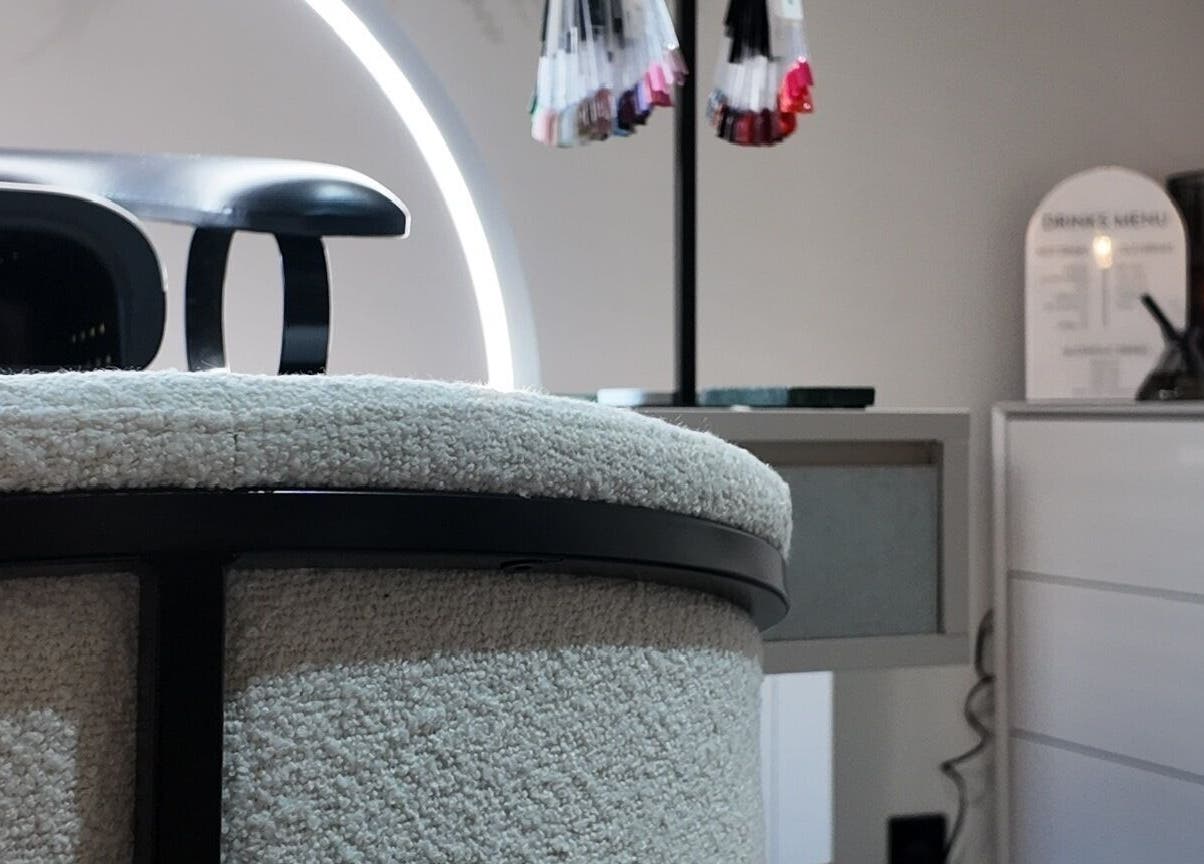 Modern chic interior of Evolved Salon, Boroughbridge, England, GB featuring stylish nail polish display.