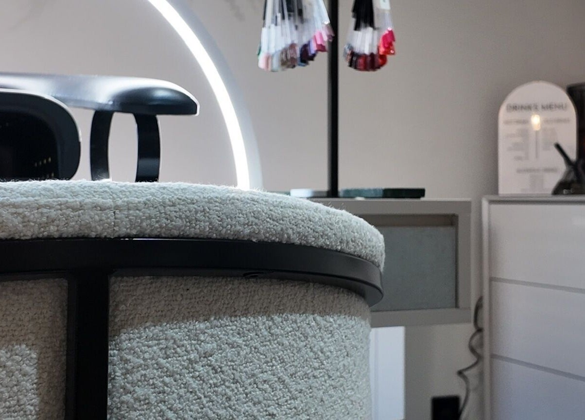 Modern chic interior of Evolved Salon, Boroughbridge, England, GB featuring stylish nail polish display.