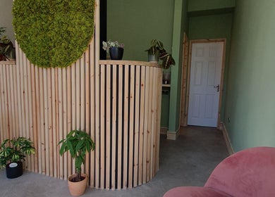 Stylish reception at CK Laser @ Salon Forty Four, Eastbourne, England, GB, showcasing natural wood and green decor.