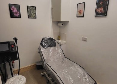 CK Laser @ Salon Forty Four in Eastbourne, England, GB offers a serene treatment room with a cushioned chair.