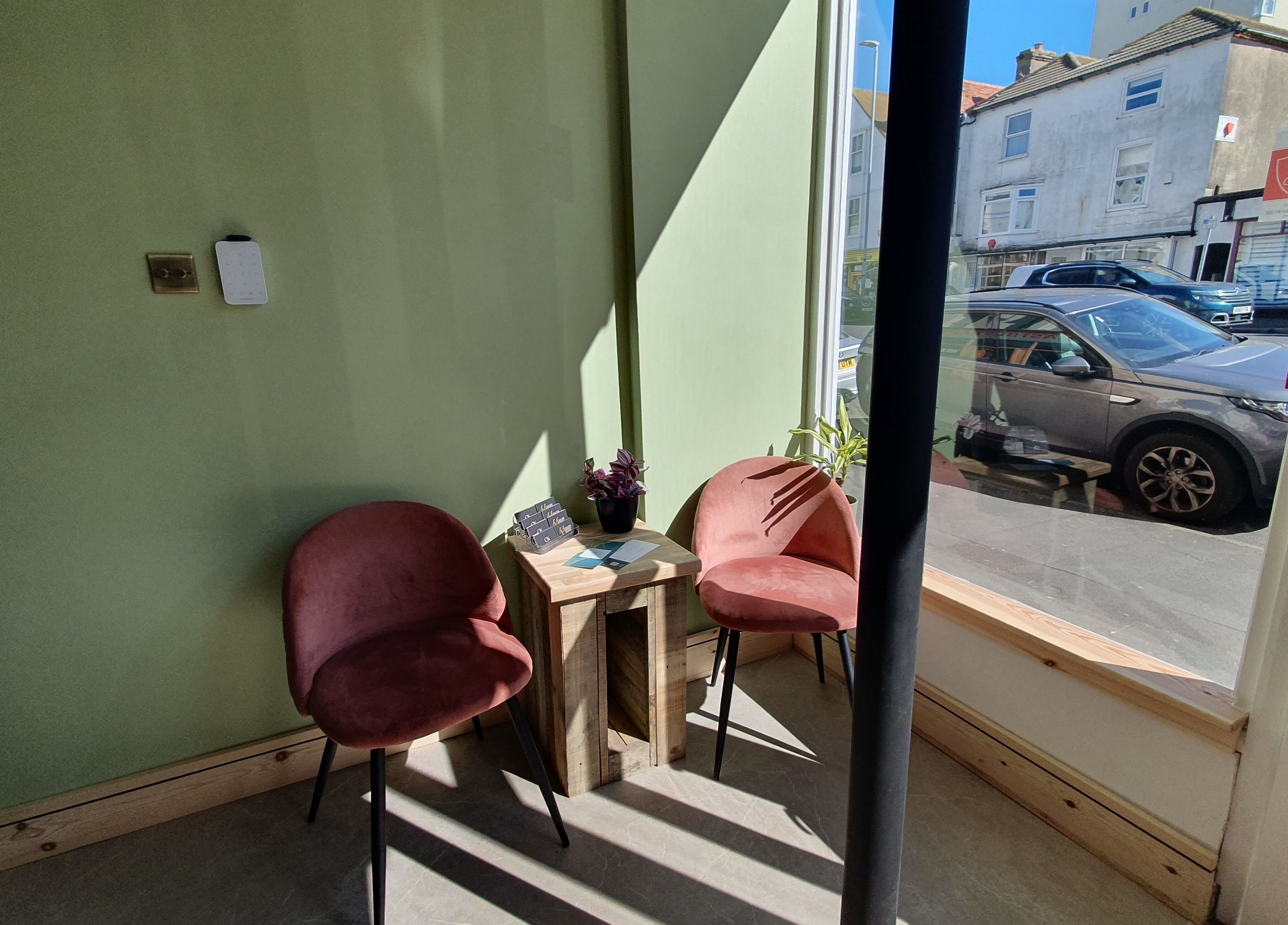 Comfortable waiting area with pink chairs at CK Laser at Salon Forty Four, Eastbourne, England, GB.