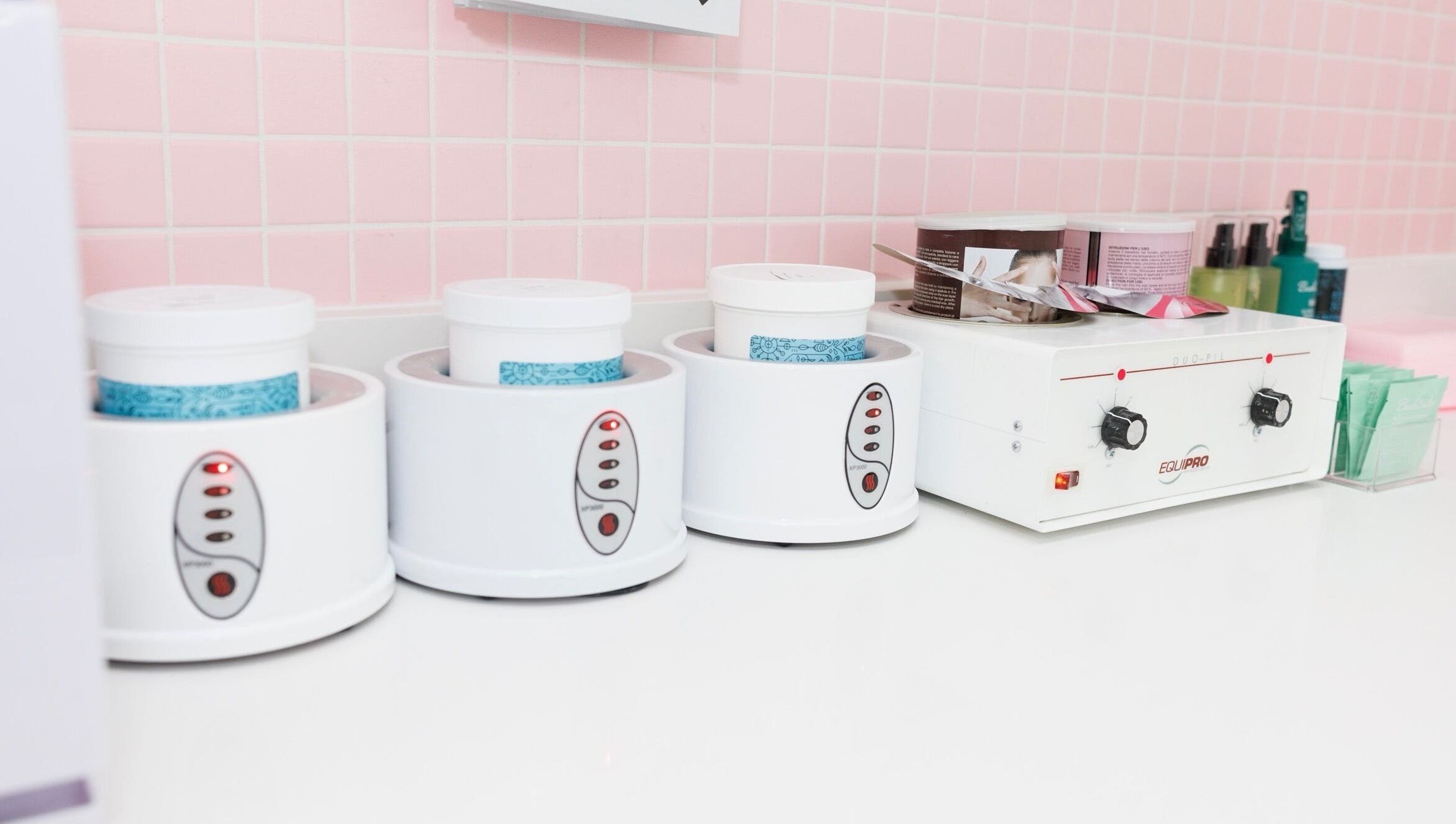 Wax warmers at Sugr Sugr Wax Bar, Ottawa, Ontario, CA, highlighting a serene and professional waxing setup.
