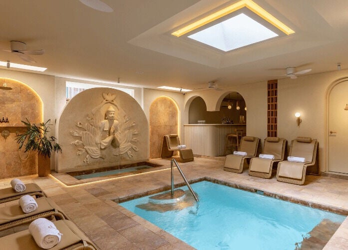 Relaxing spa pool area at Asai Spa, Bali, Bali, ID with elegant lounge chairs and tranquil décor.