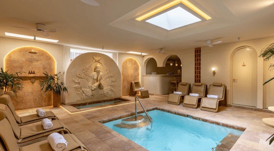 Relaxing spa pool area at Asai Spa, Bali, Bali, ID with elegant lounge chairs and tranquil décor.