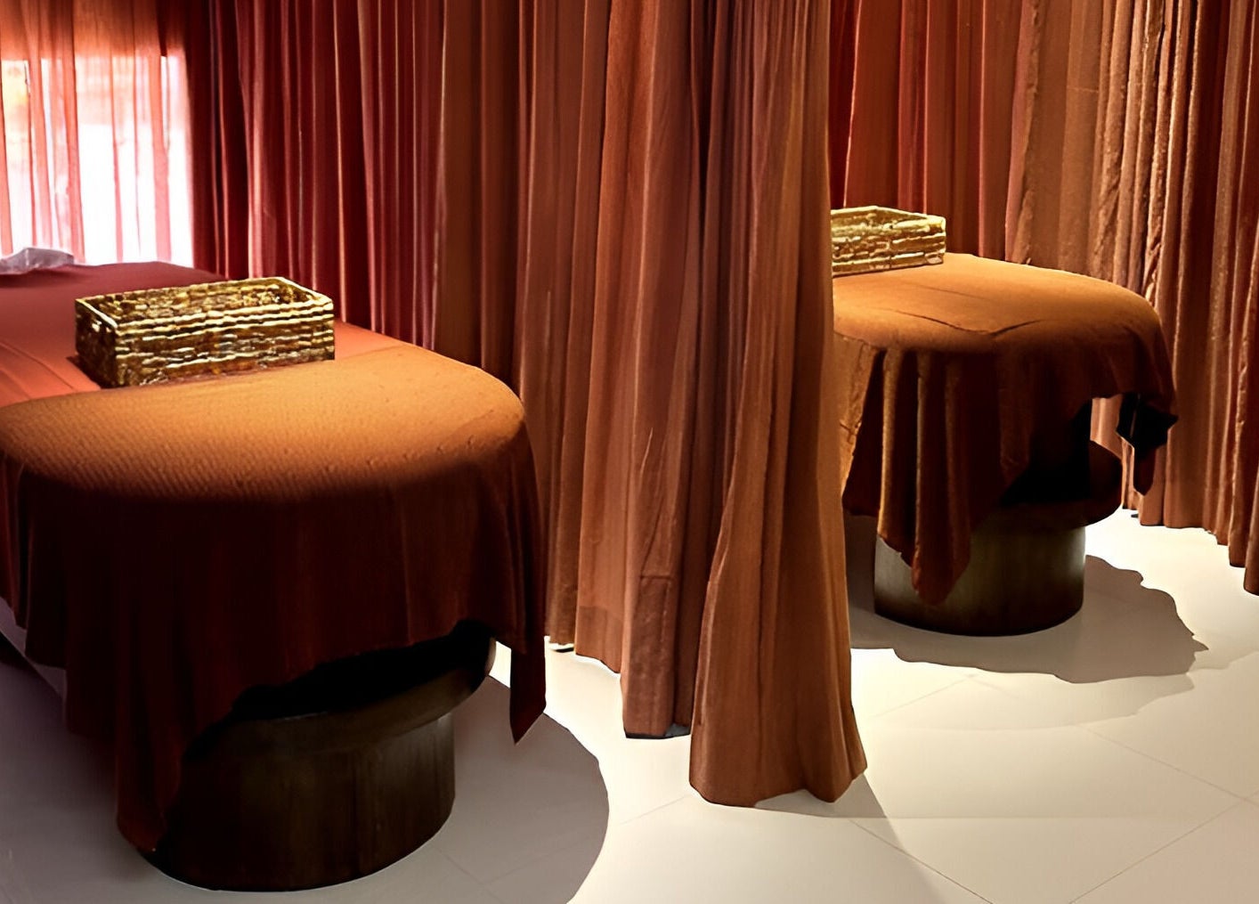 Calm massage room at Asai Spa, Bali, Bali, ID with two cozy beds and amber curtains.