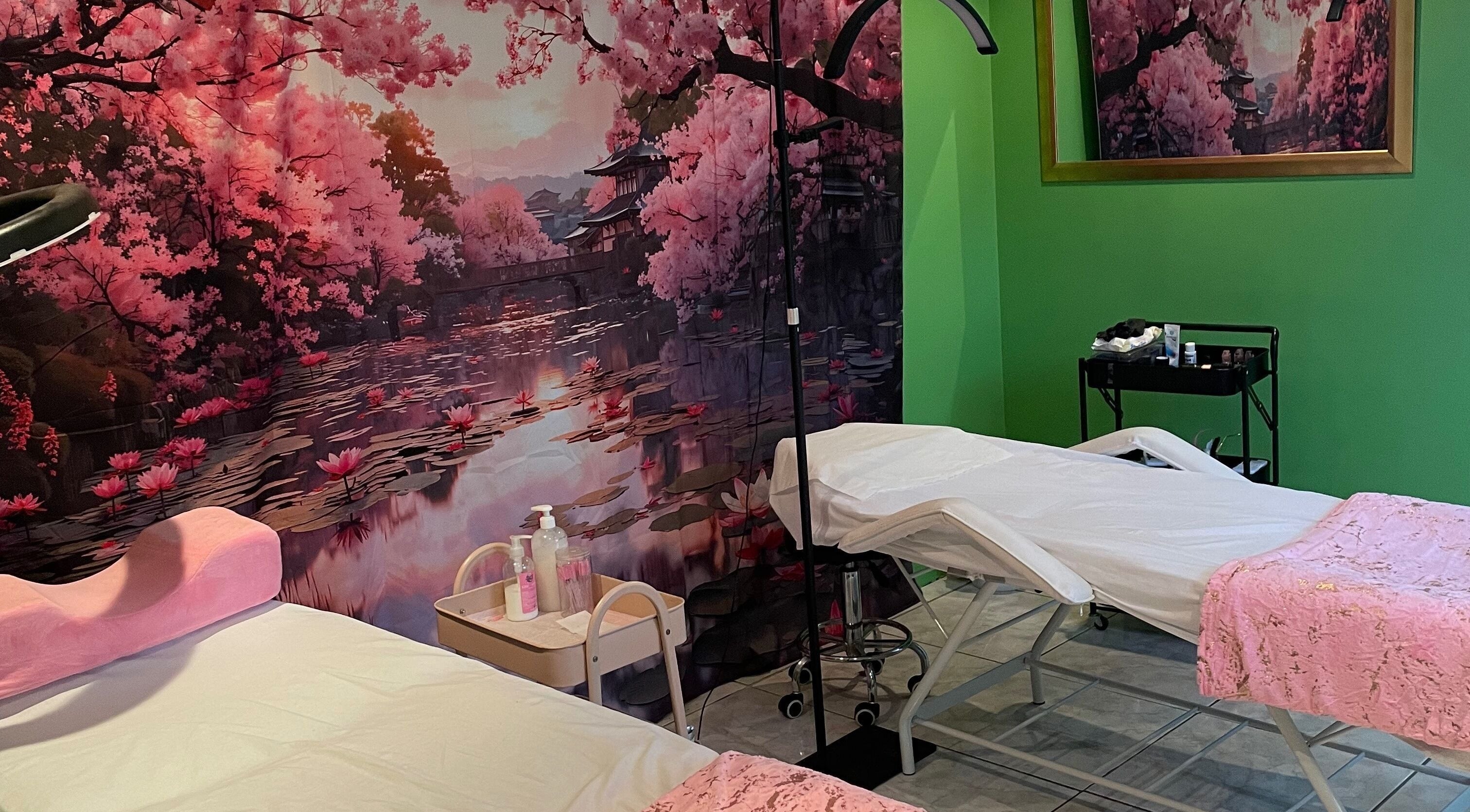 Defined Elegance massage room in Durban North, Kwazulu-natal, ZA with cherry blossom decor and treatment beds.