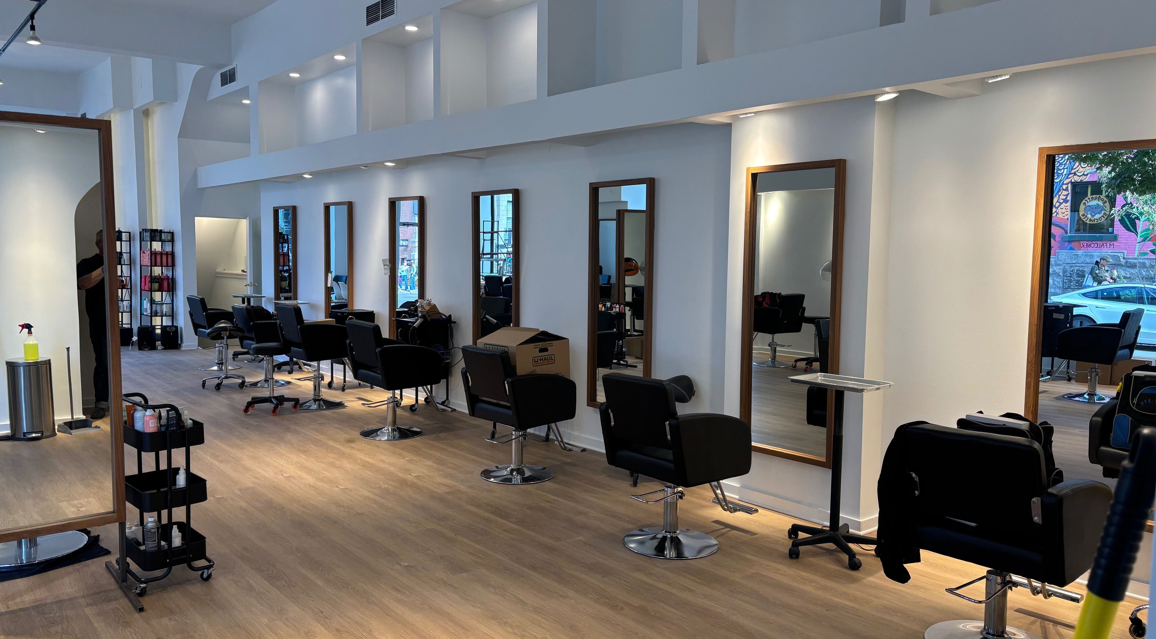 Intérieur moderne du salon Ka Coiffure à Montréal, Québec, CA avec stations de coiffure chic.