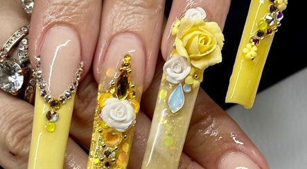Intricate yellow nail art with floral design at Artistry Lash Brows & Nails Studio, Twin Falls, Idaho, US.
