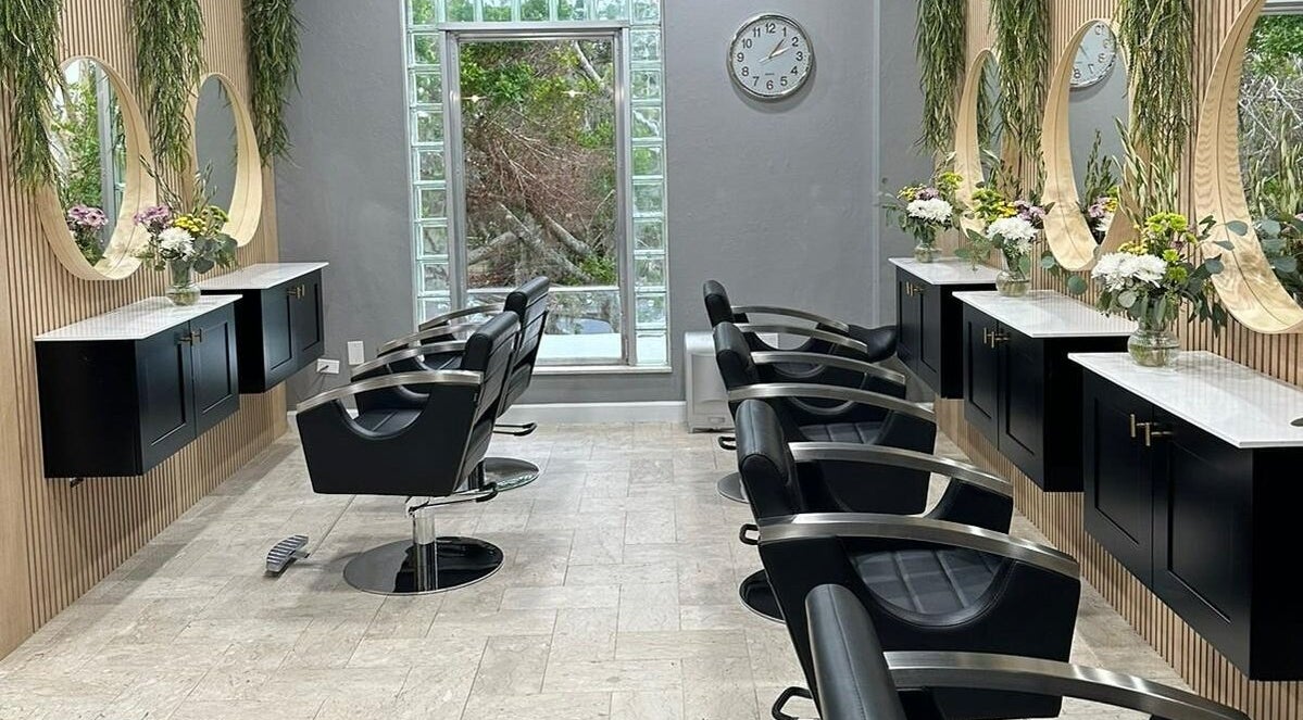 Modern styling chairs and mirrors at RC Hair Salon in Fort Myers, Florida, US, elegantly arranged for a serene ambiance.