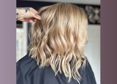 Blonde hair styled in wavy curls at Five One Four salon, Littlehampton, England, GB.
