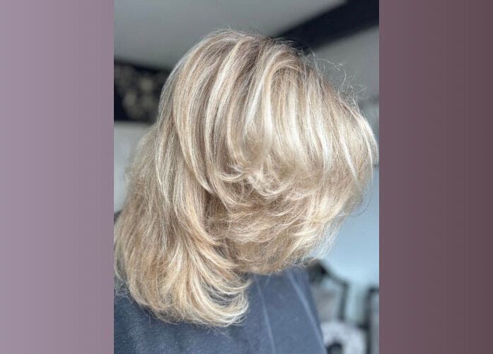 Blonde layered hairstyle at Five One Four, Littlehampton, England, GB, showcasing elegant waves.