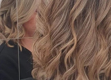 Blonde curls styled at ES Collective, Hornchurch, England, GB, reflected in the mirror.