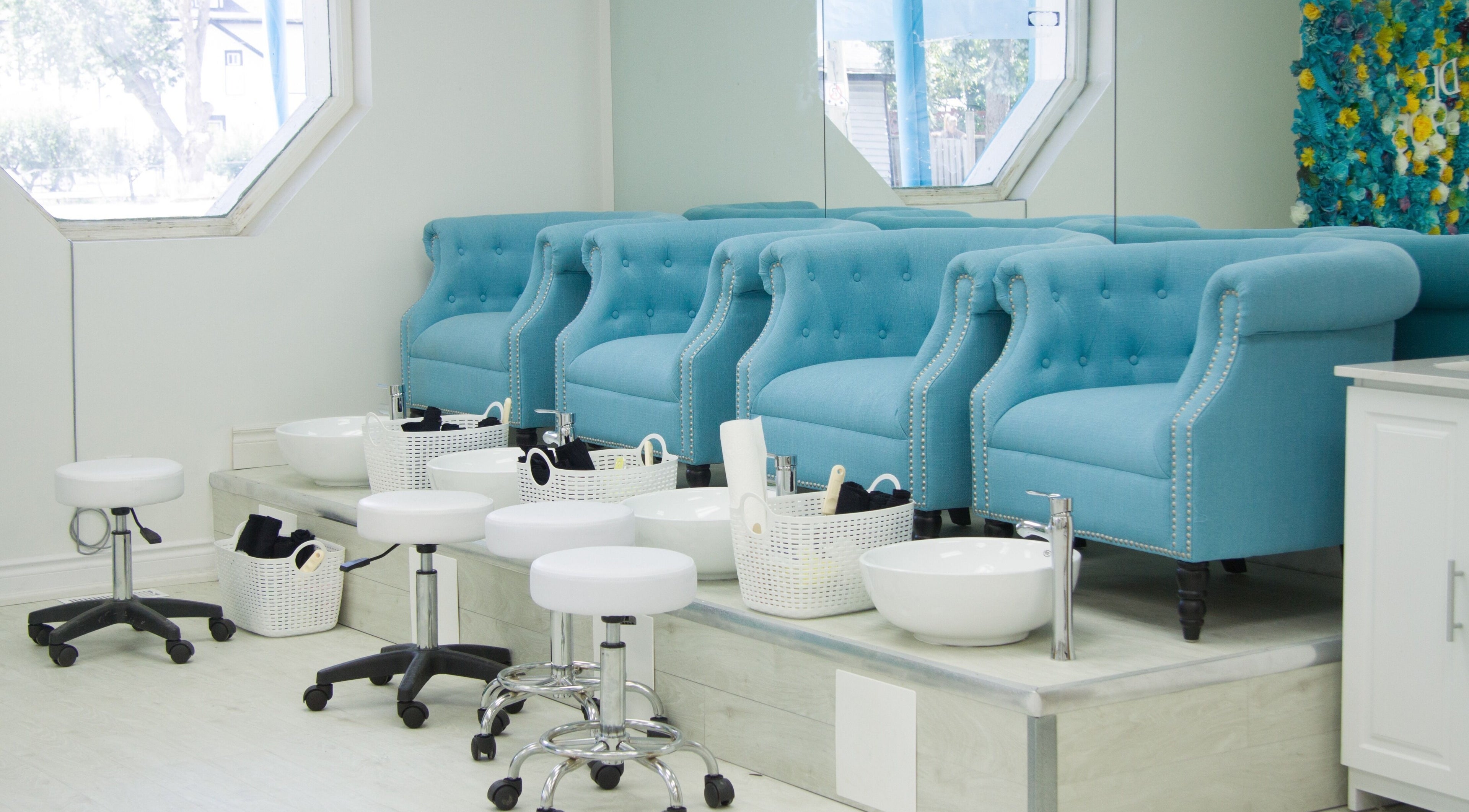 Elegant pedicure stations at Doll House 905, Brampton, Ontario, CA, featuring plush blue chairs.