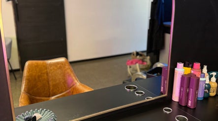 Cozy salon chair at Tanya J Hairstylist, Fortitude Valley, Queensland, AU, with sleek products on display.