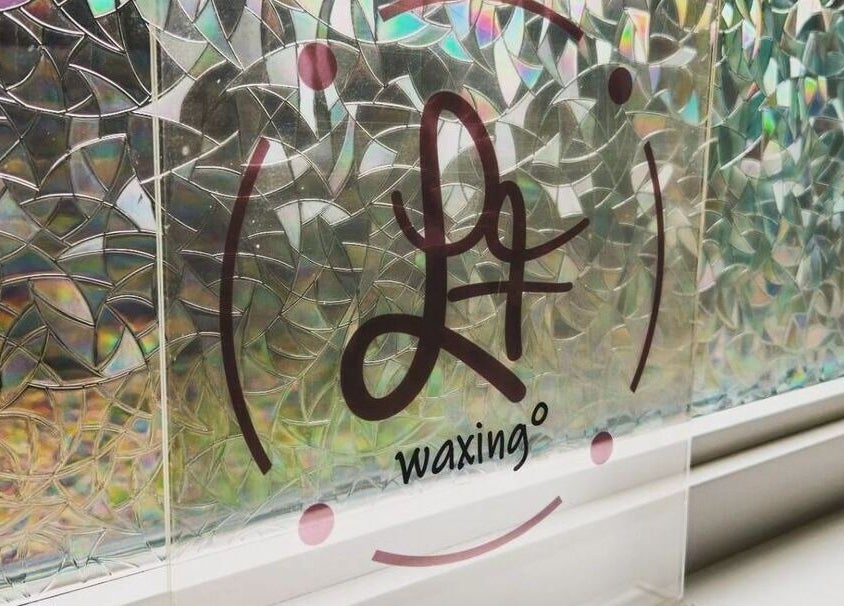 Intricate glass design featuring L.F Waxing logo at Montreal, Québec, CA.