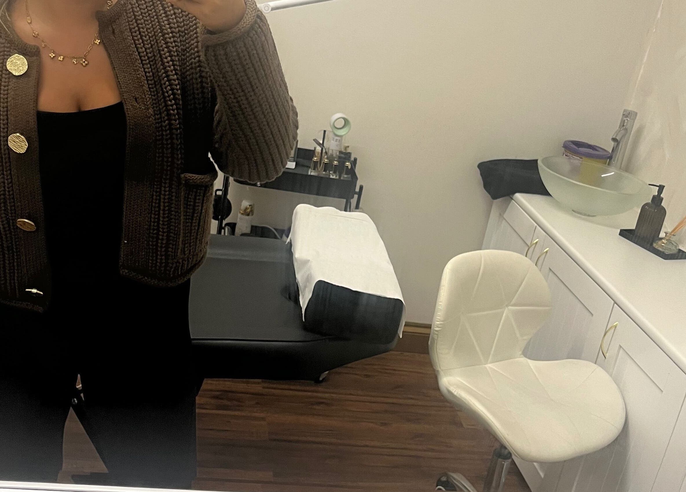 A comfortable treatment room at Enhanced by mtb in Hull, England, GB, featuring a chair and treatment bed.