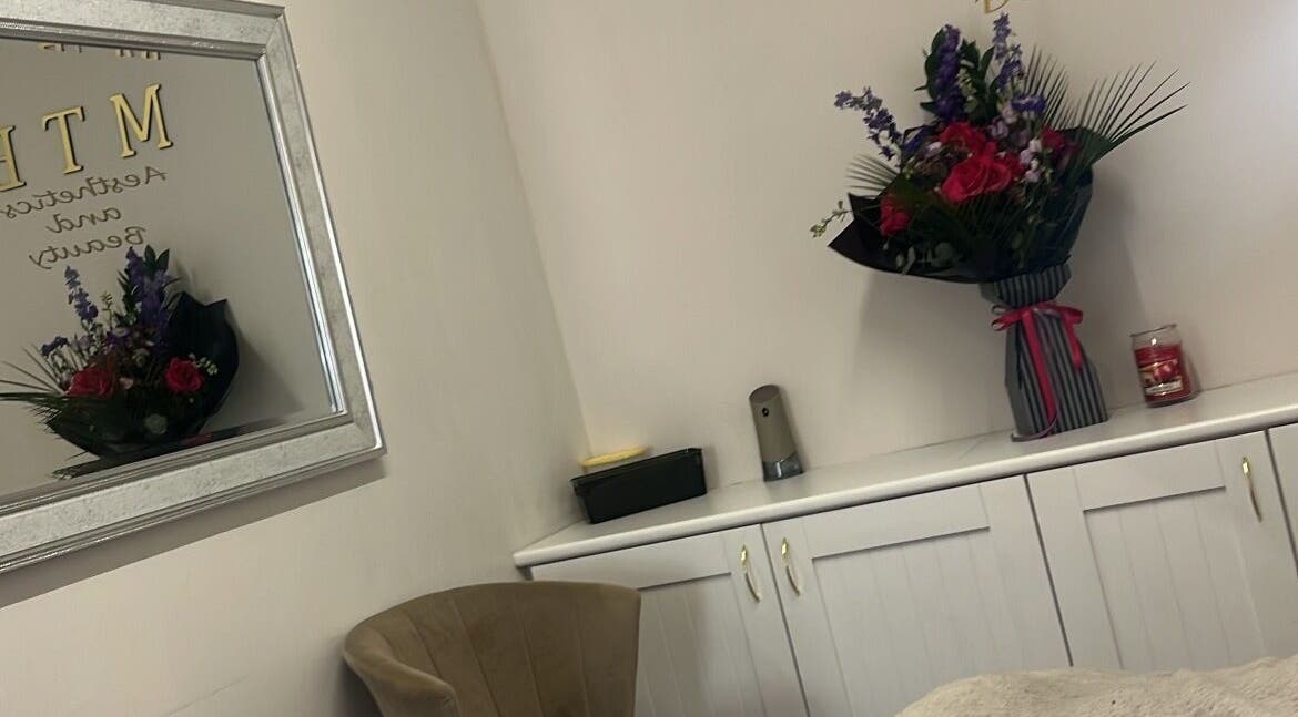 Elegant decor at Enhanced by mtb in Hull, England, GB with a mirror and floral arrangement.