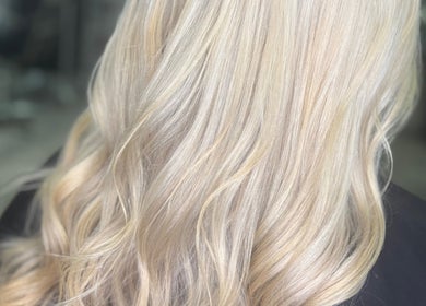 Elegant blonde waves styled at Cove Hair Beauty Wellness in Padstow, England, GB.