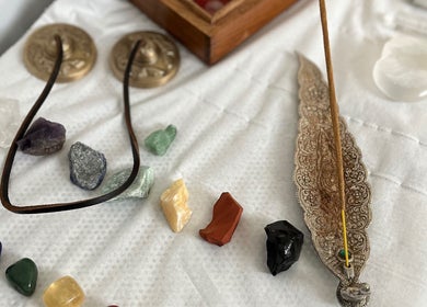 Assorted crystals and incense on a white cloth at Aura and Earth, Taunton, England, GB.
