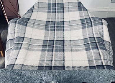 Relaxing therapy bed at Aura and Earth, Taunton, England, GB with a plaid blanket creating a serene atmosphere.