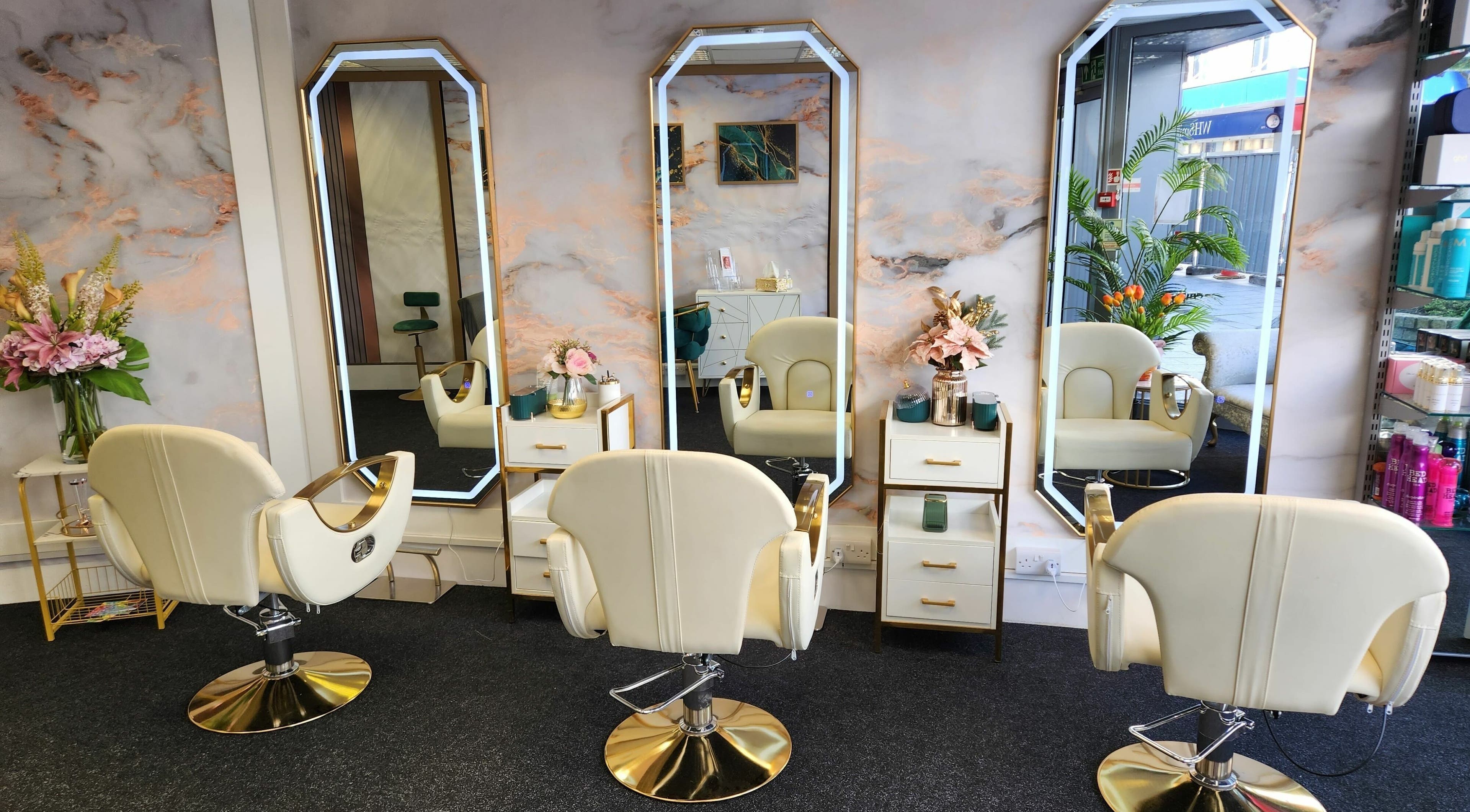 Spacious and chic interior of Jazz Beauty Clinic and Training in Torquay, England, GB with stylish chairs and mirrors.
