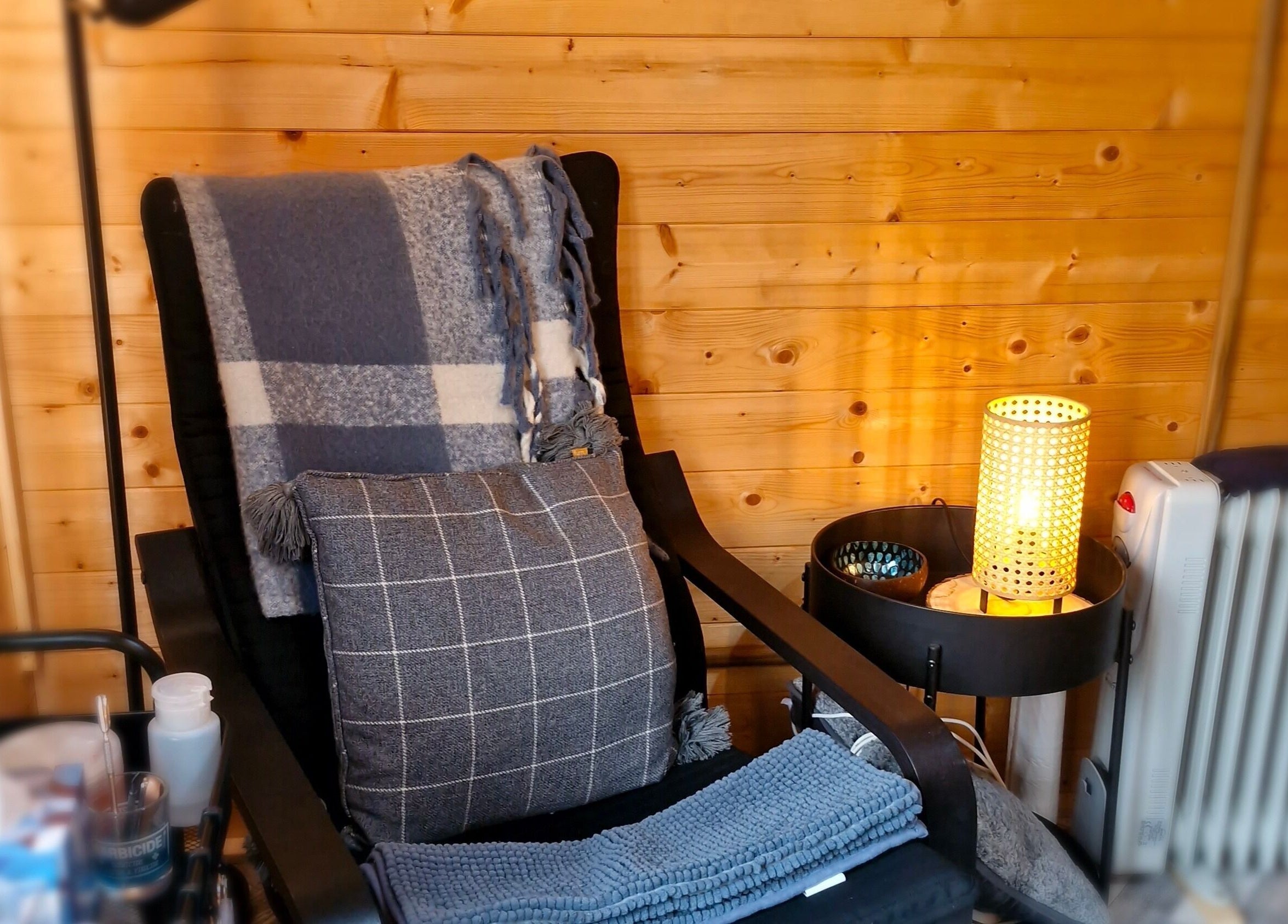 Relaxing chair setup in a warm, wooden interior at Bare Essential Beauty, Addington, England, GB.