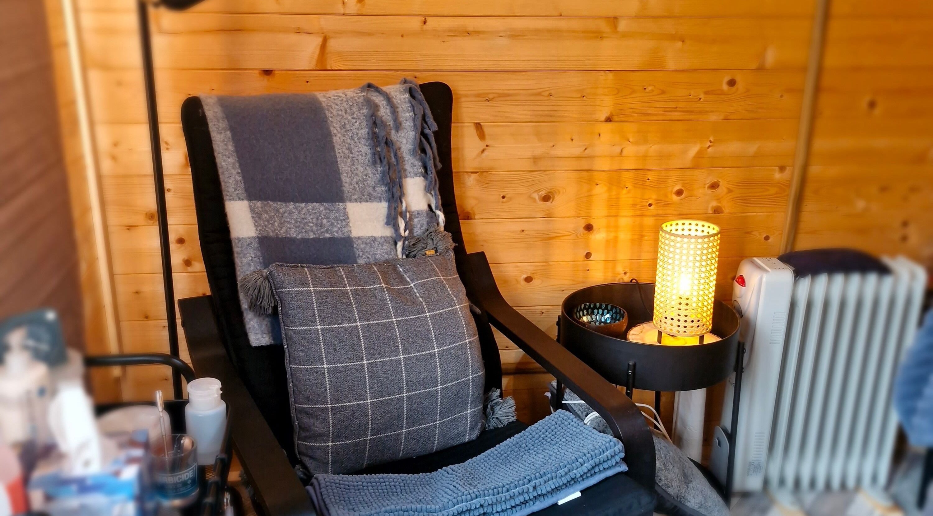 Relaxing chair setup in a warm, wooden interior at Bare Essential Beauty, Addington, England, GB.