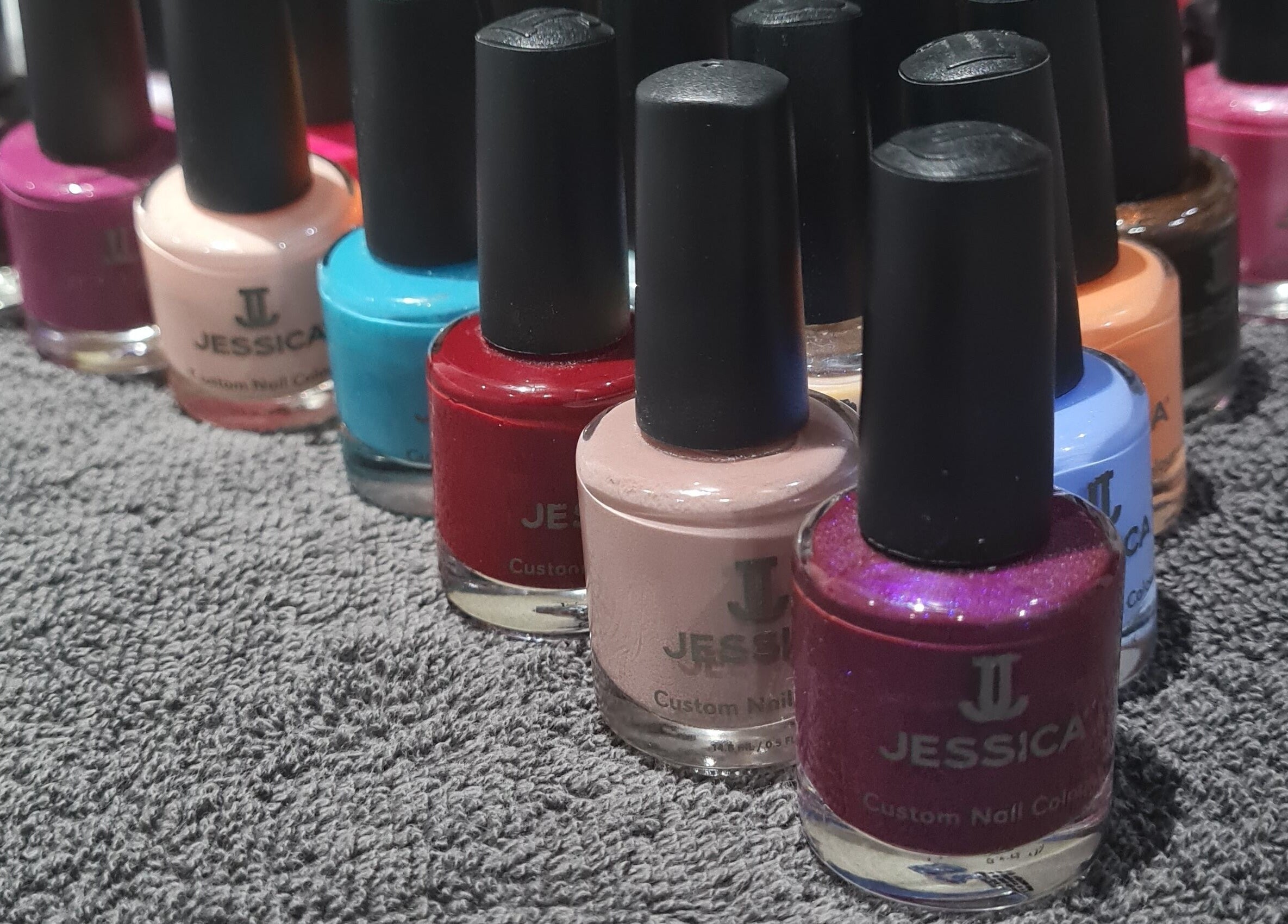 Colorful nail polishes at Bare Essential Beauty in Addington, England, GB, offering vibrant manicure services.