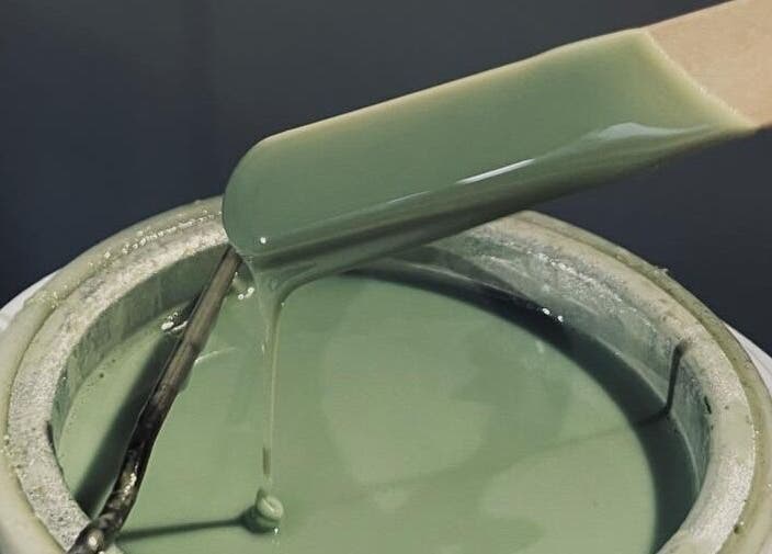 Green wax being prepared at Bare Essential Beauty in Addington, England, GB for a soothing waxing experience.