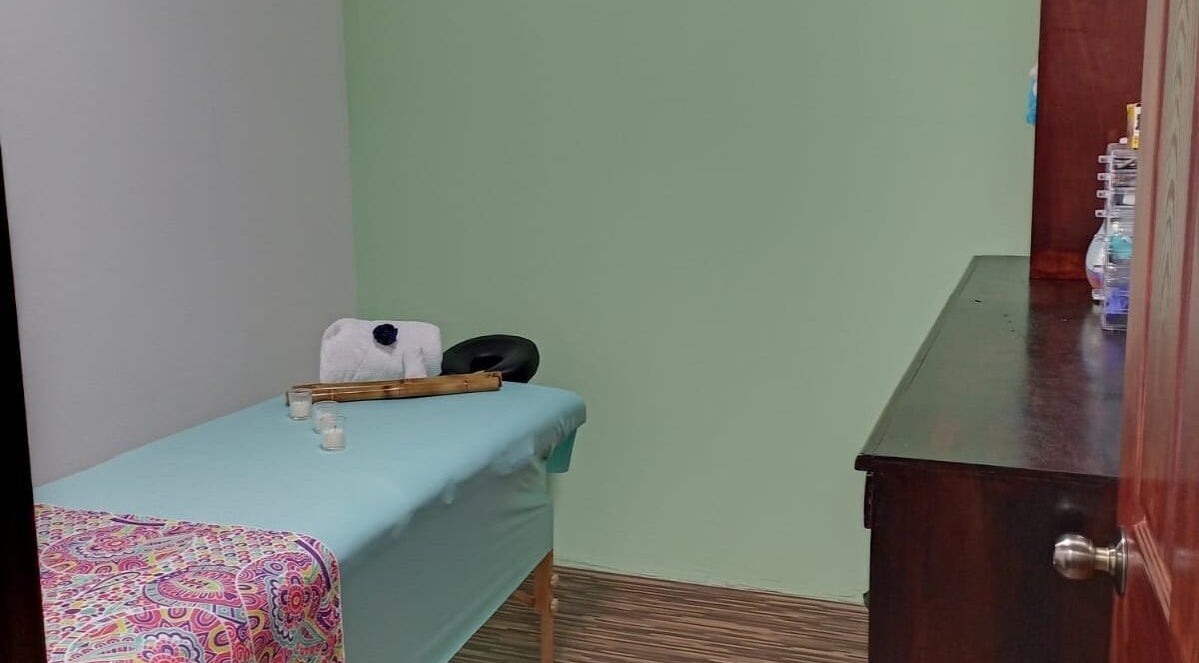 Sala de masajes en Yiyi Estética y Spa, Desamparados, San José, CR, con cama y decoración relajante.