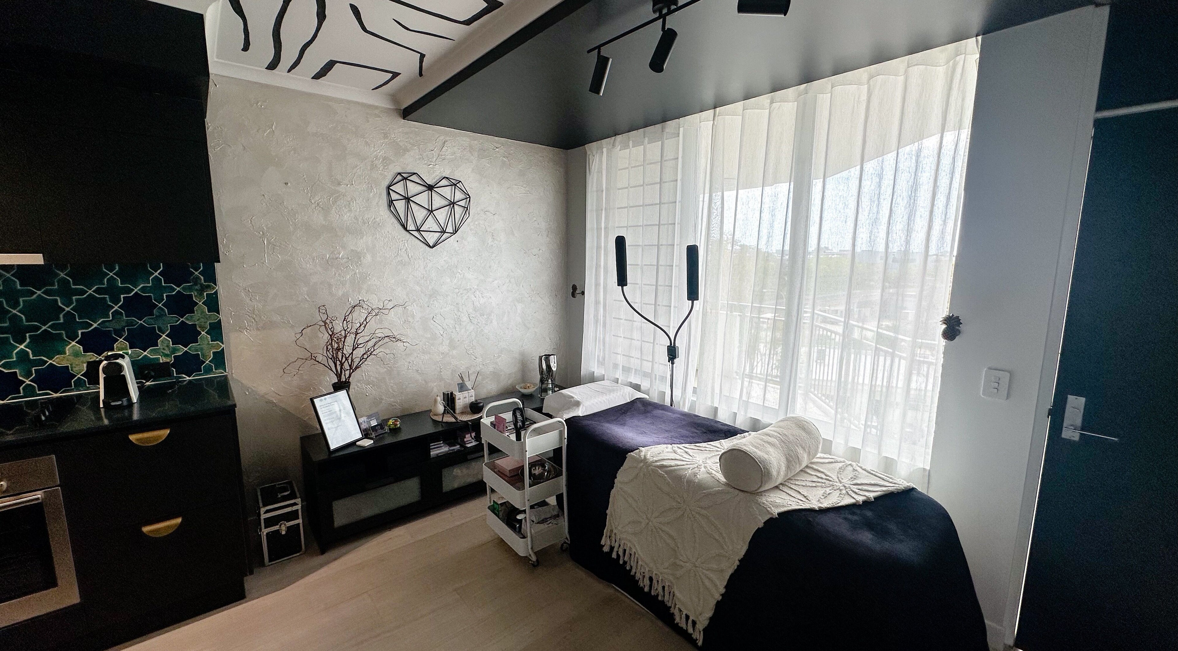 EYESMILE ARTISTRY's elegant beauty suite in Maroochydore, Queensland, AU with stylish decor and treatment bed.