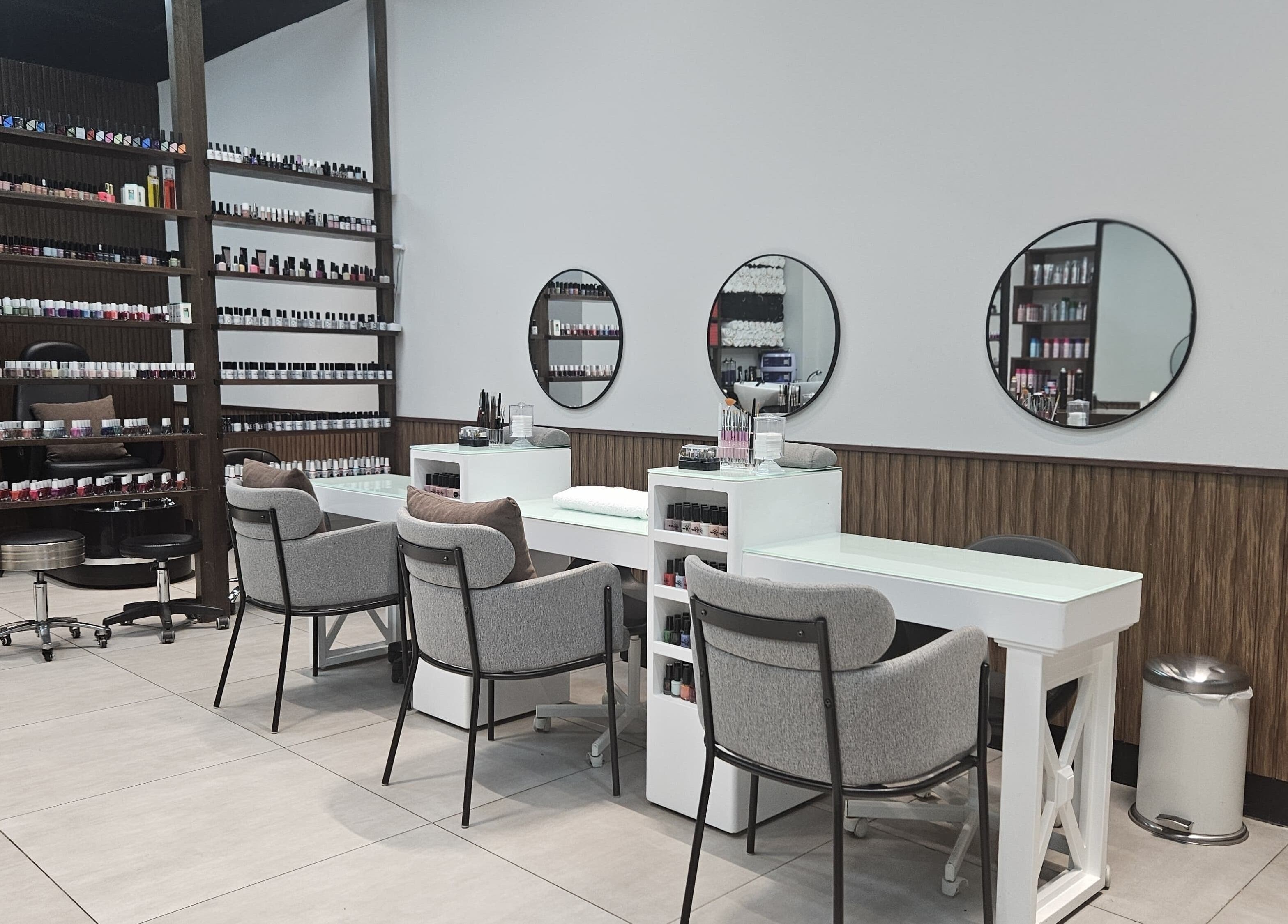 Modern nail station at BB Salon Hair & Beauty, Dubai, Dubai, AE showcasing sleek design and ample polish selection.