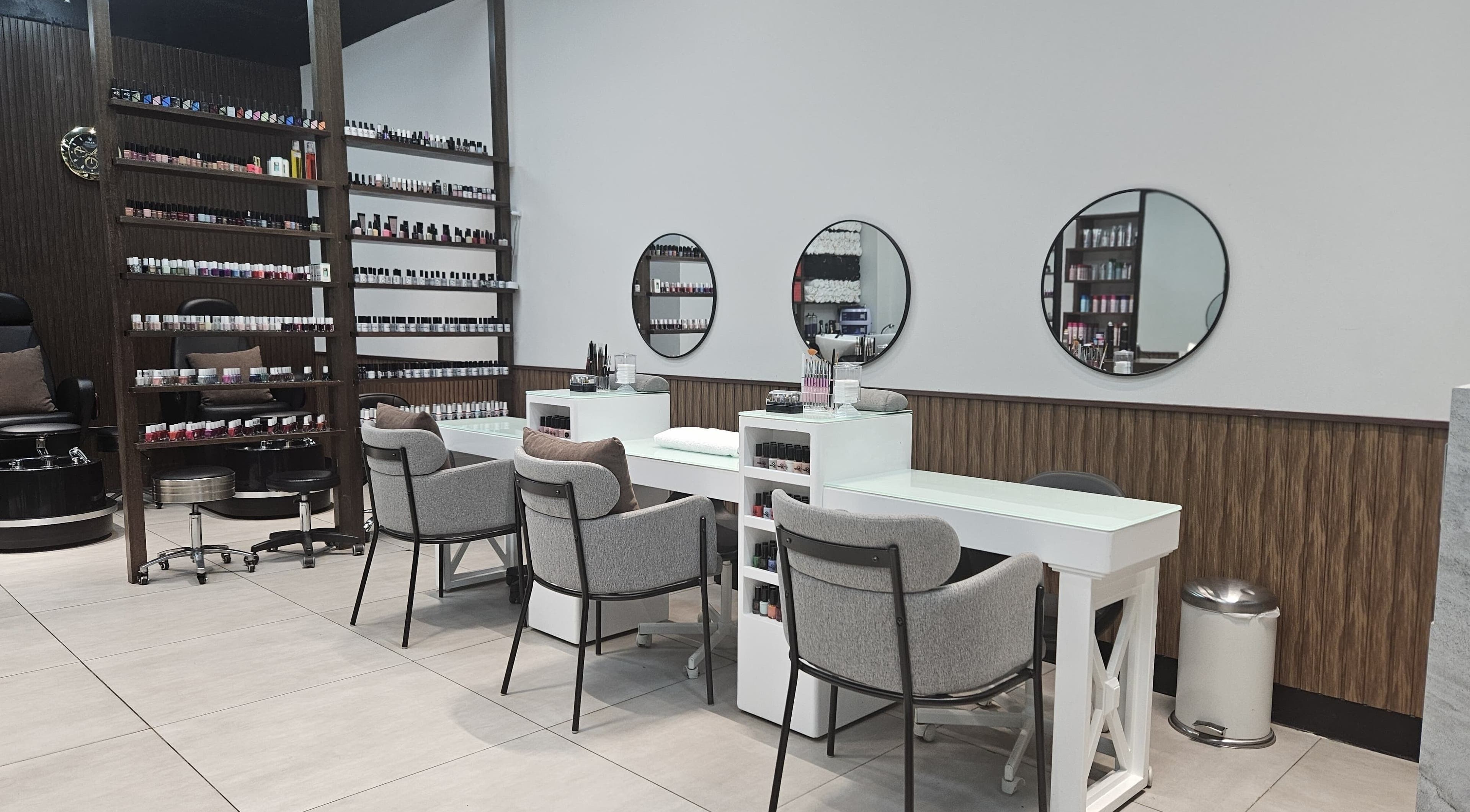 Modern nail station at BB Salon Hair & Beauty, Dubai, Dubai, AE showcasing sleek design and ample polish selection.