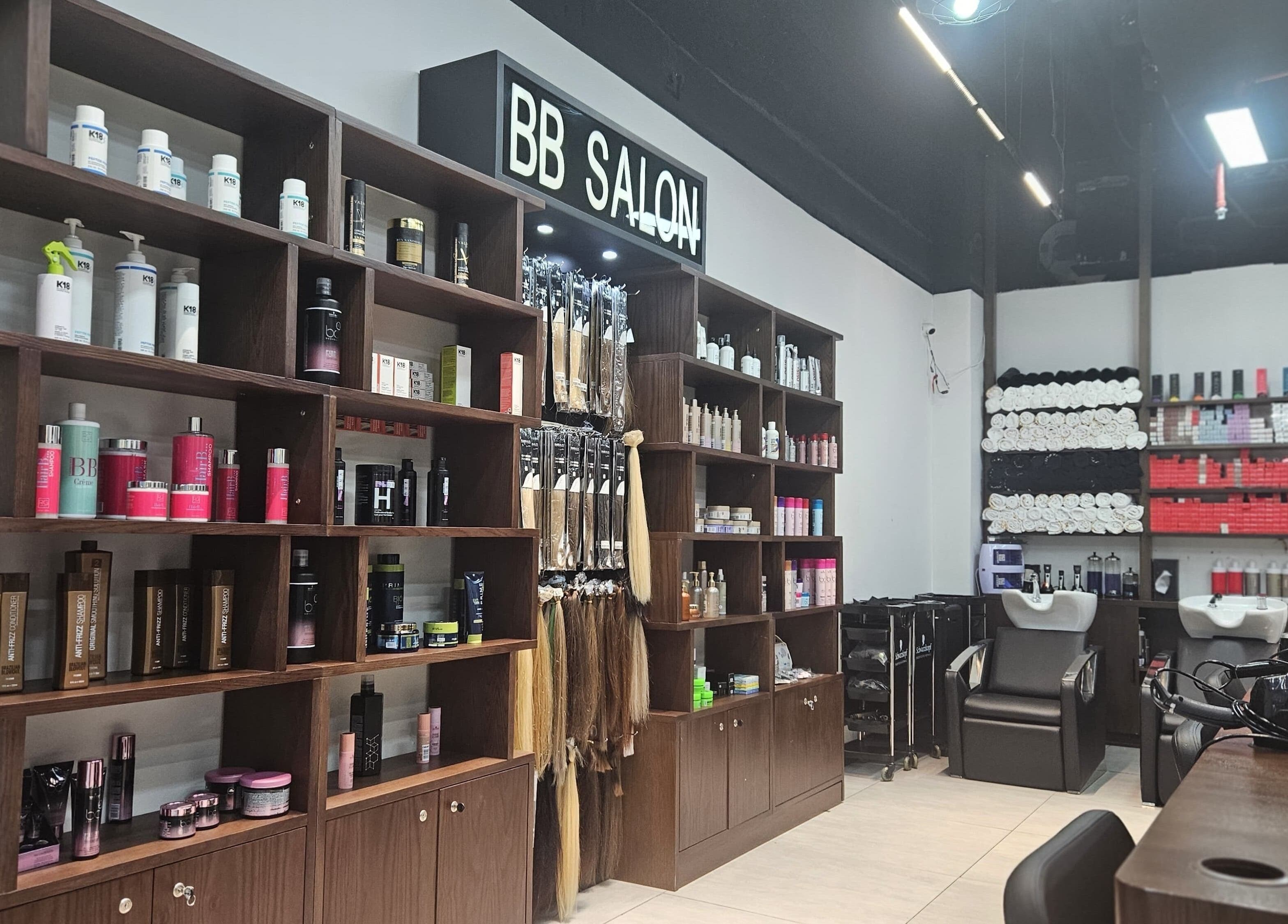 Interior of BB Salon Hair & Beauty in Dubai, AE showcasing product shelves and hair stations.