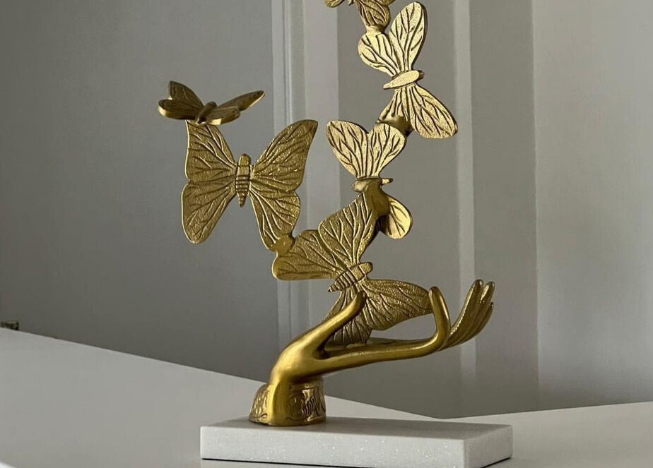 Elegant gold butterfly sculpture at Sass Aesthetics Training Academy, Milnrow, England, GB.