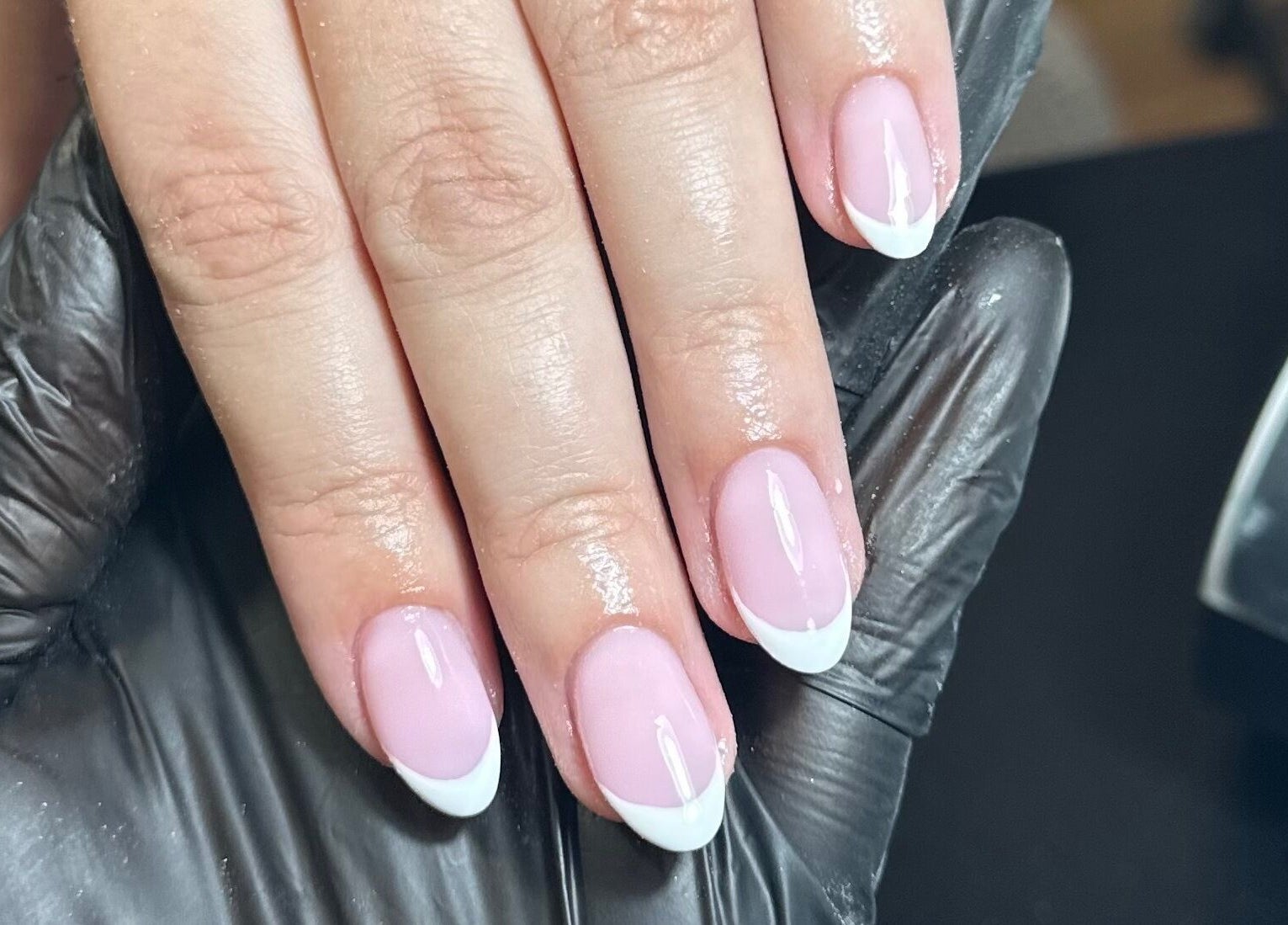 Beautiful French manicure at Libby’s Beauty in Welcombe, England, GB, showcasing glossy pink and white nails.