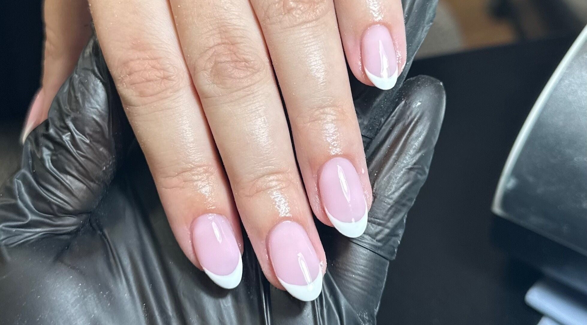Beautiful French manicure at Libby’s Beauty in Welcombe, England, GB, showcasing glossy pink and white nails.