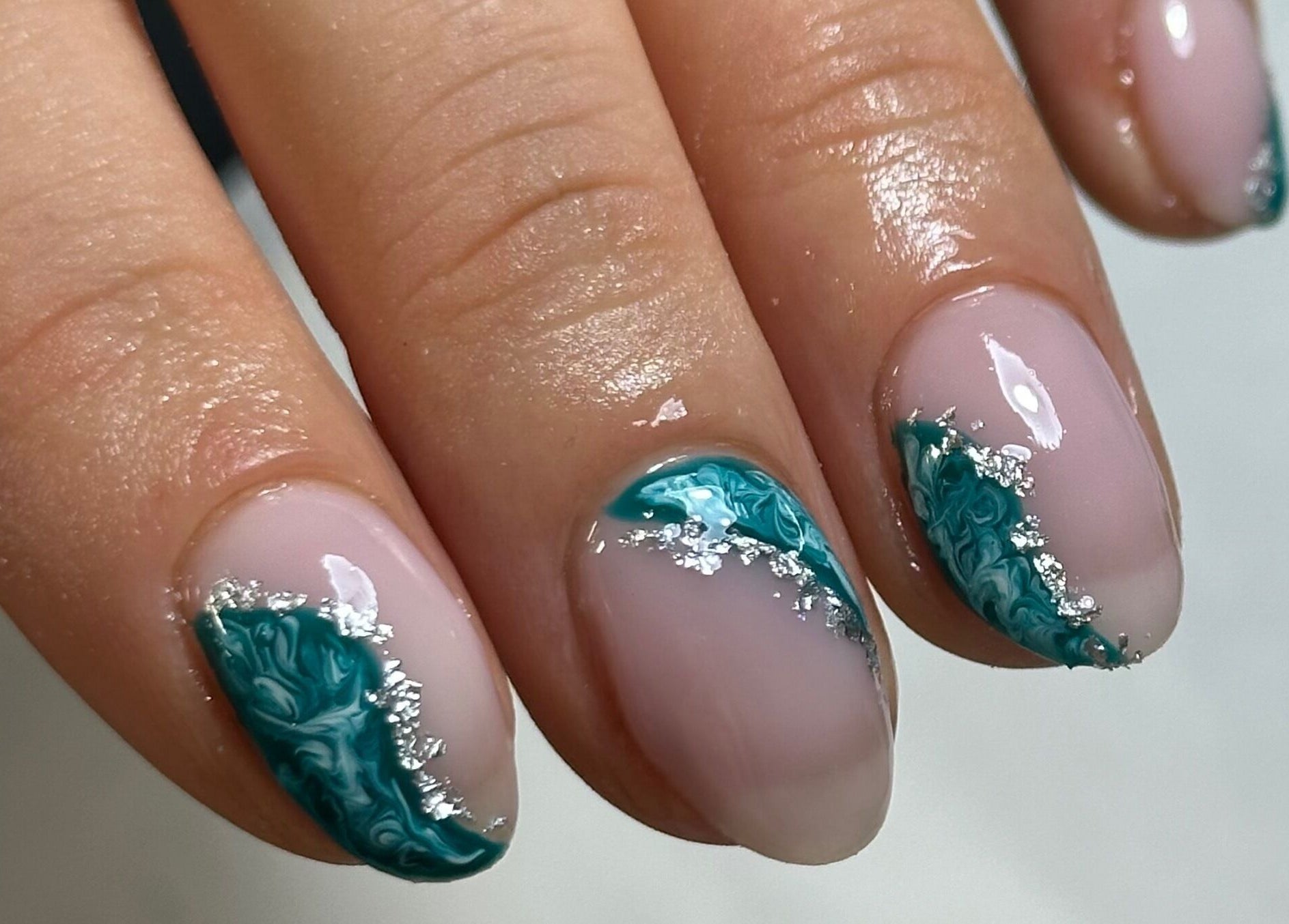 Elegant teal and silver nail art at Libby’s Beauty, Welcombe, England, GB.